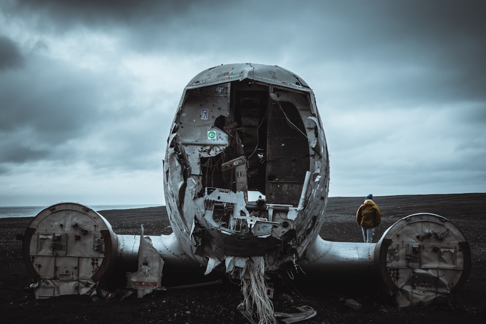 man beside wrecked plane