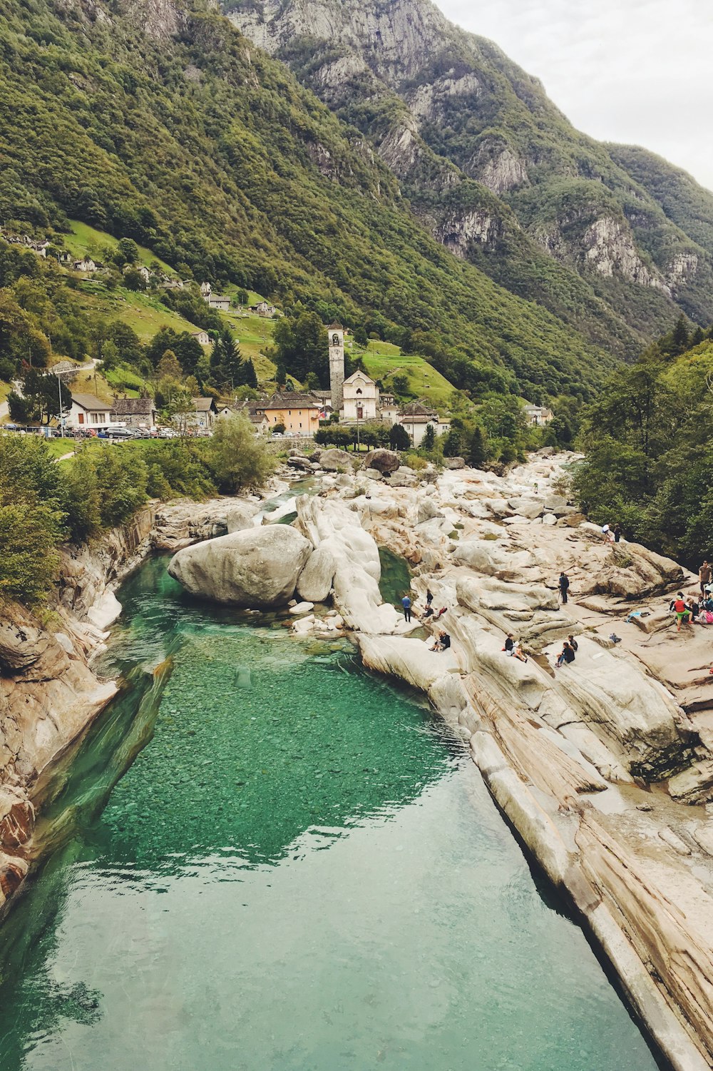 top view of cathedral, body of water, and mountain