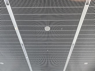 the ceiling of a building with a clock on it