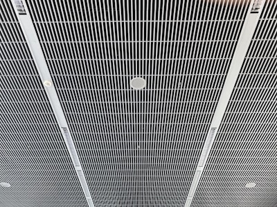 the ceiling of a building with a clock on it