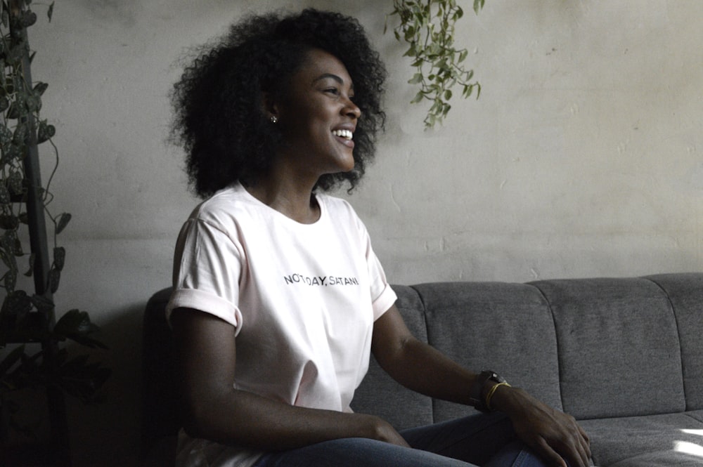 woman smiling sitting on sofa