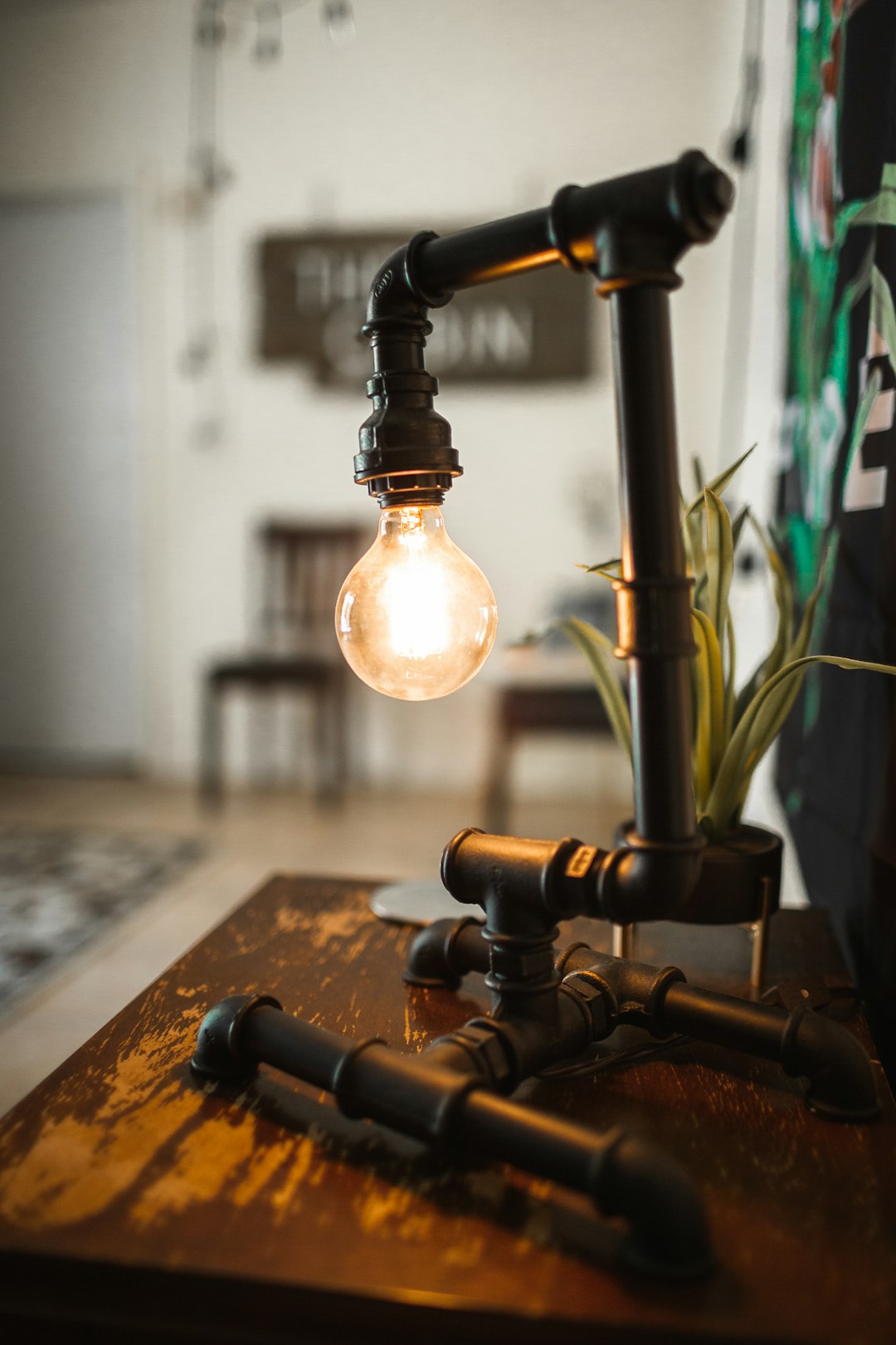 black pipe table lamp on wooden surface