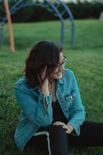 woman sitting on grass field