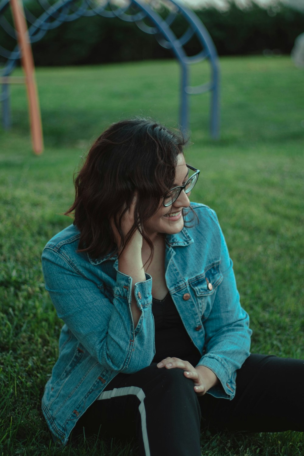 woman sitting on grass field