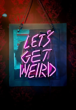 shallow focus photo of let's get weird neon light signage