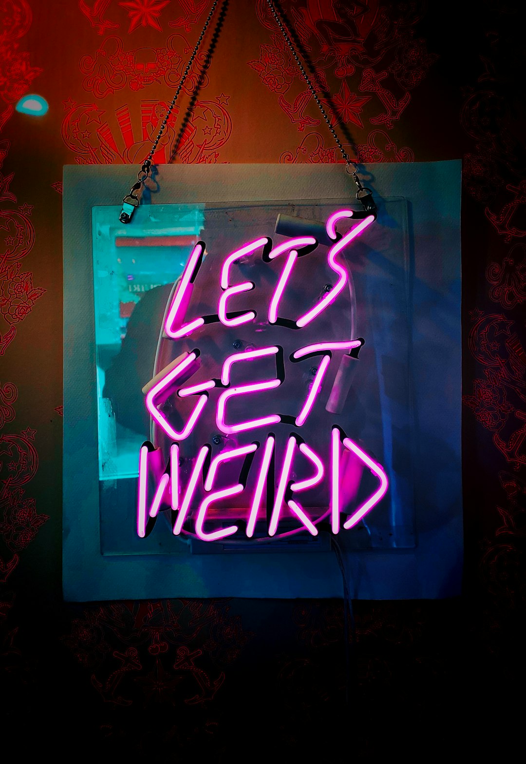shallow focus photo of let's get weird neon light signage