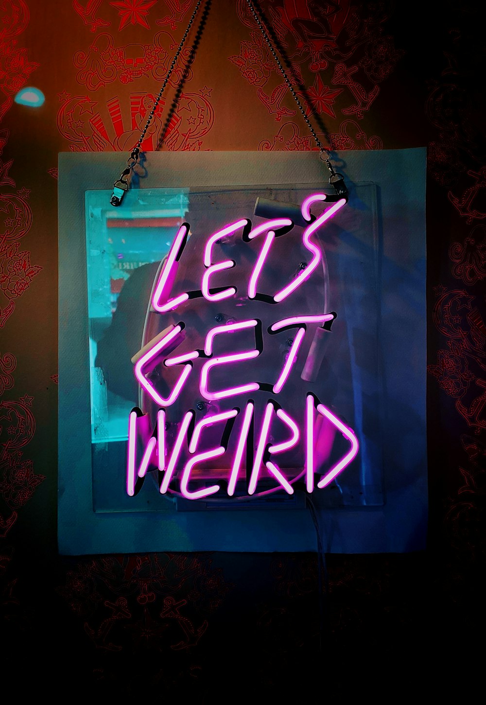 shallow focus photo of let's get weird neon light signage
