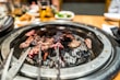 Close-up of sturdy iron barbecue tools resting on a wooden table