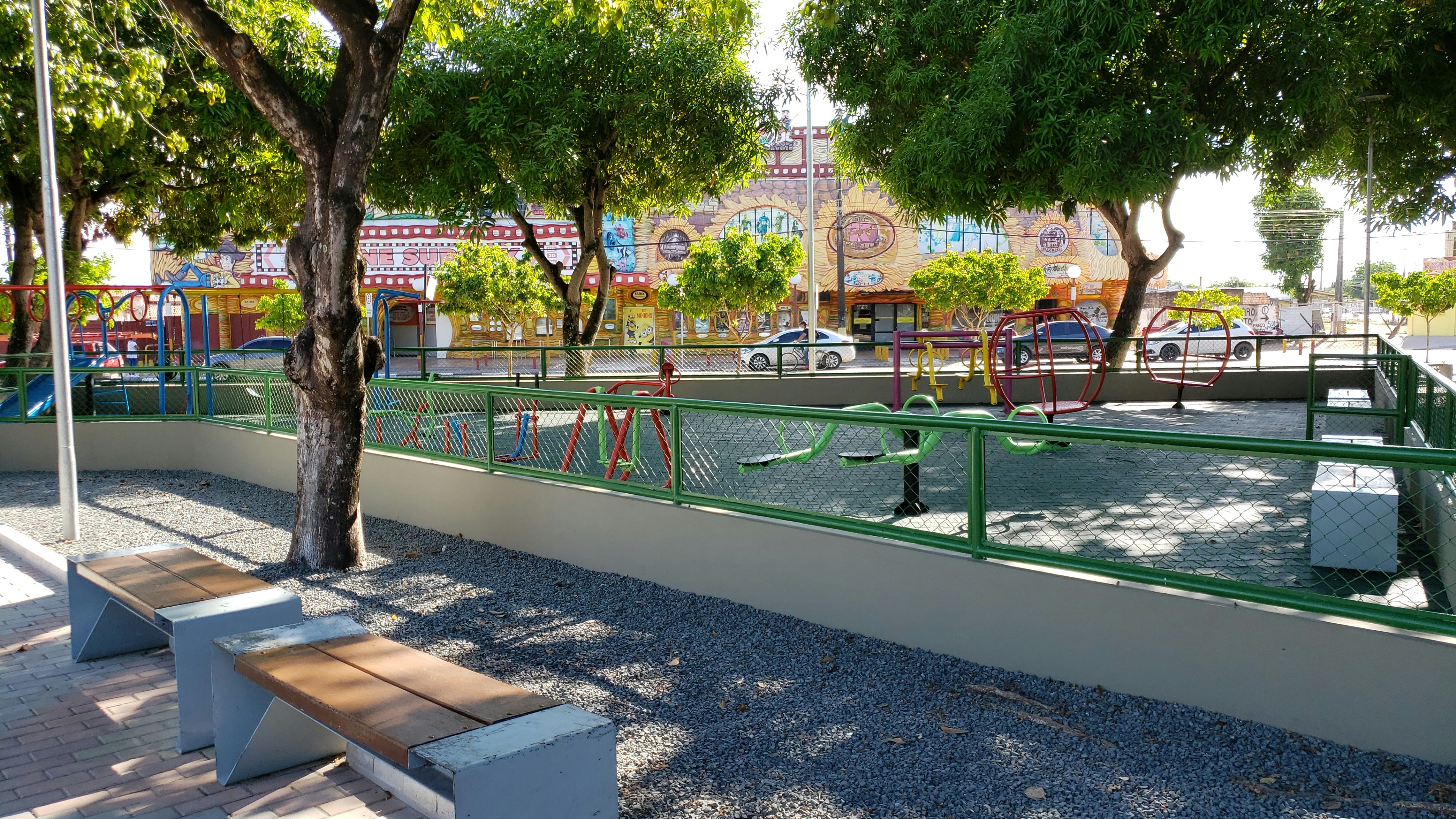 Children playing on colorful outdoor playground equipment in sunny garden