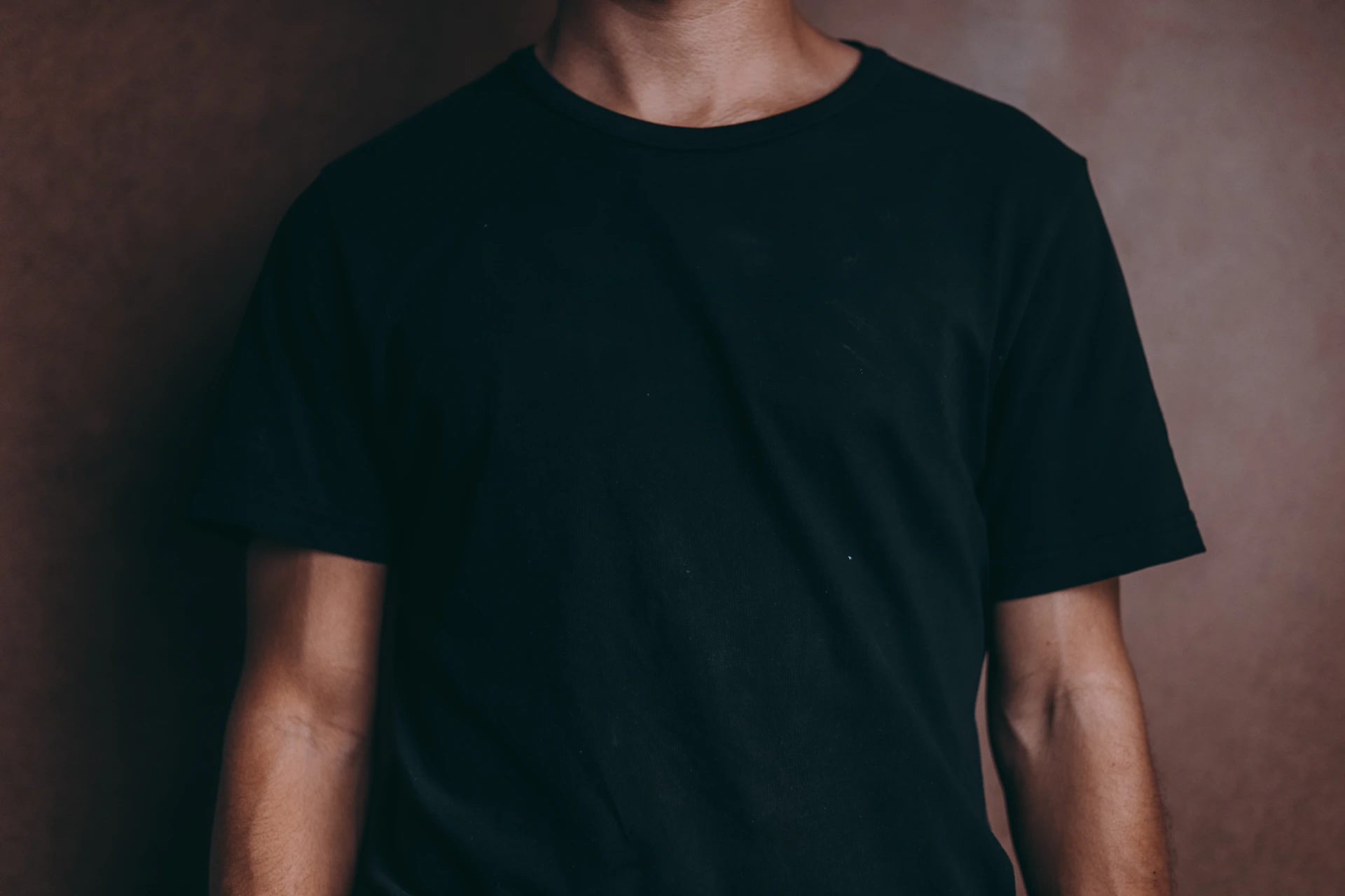 man wearing black crew-neck t-shirt