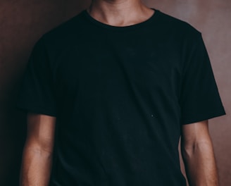 man wearing black crew-neck t-shirt