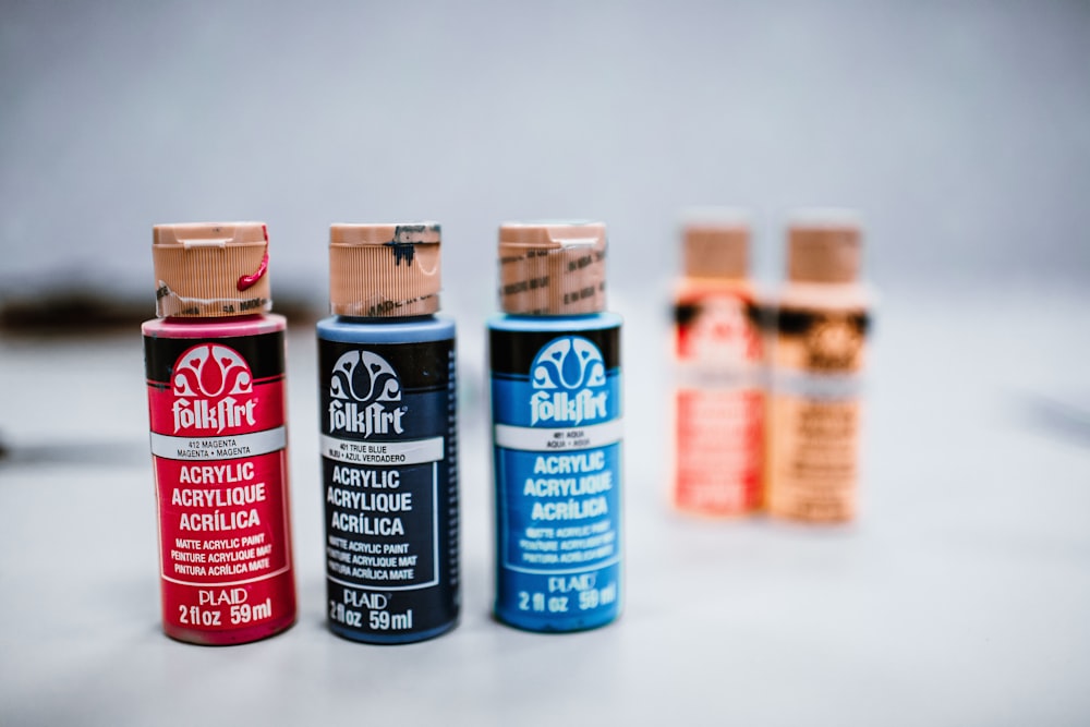 three red, blue, and black paints