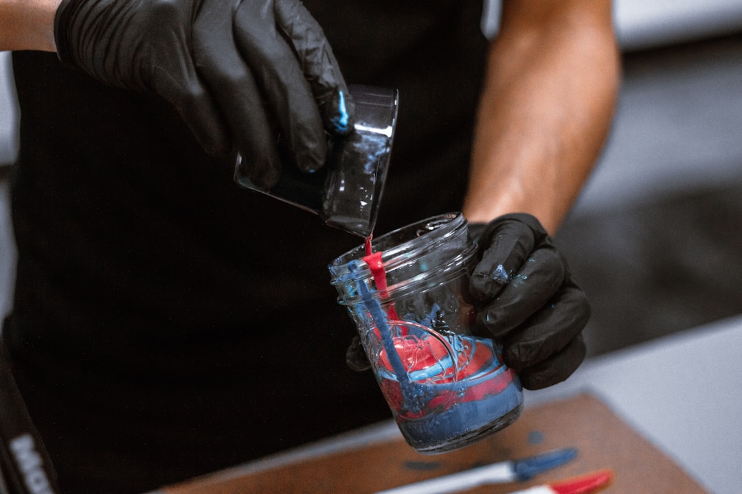 shallow focus photo of person holding glass cup