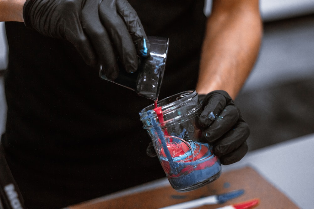 shallow focus photo of person holding glass cup