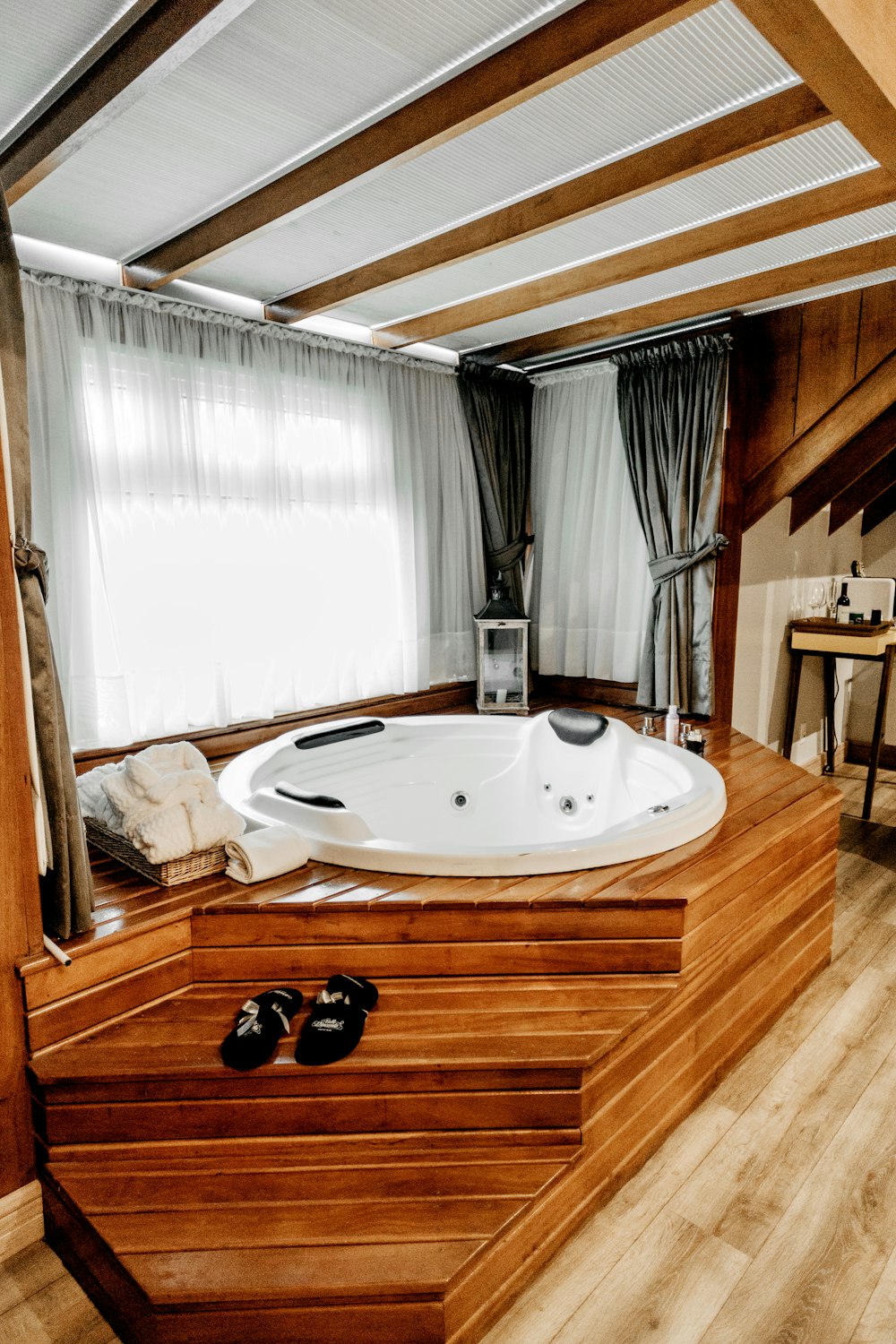Bañera de hidromasaje redonda con estructura de madera marrón
