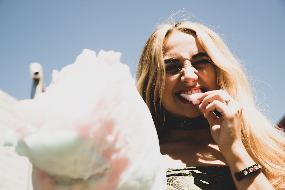 woman eating cotton candy