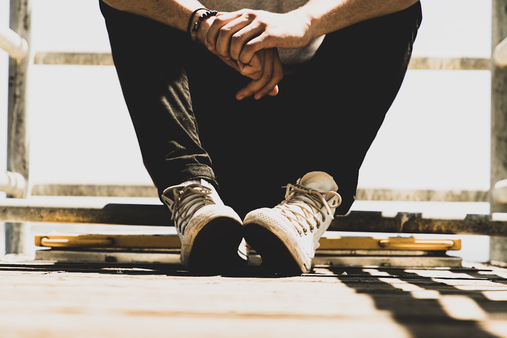 Person Sitting On Metal Bench Photo Free Apparel Image On Unsplash