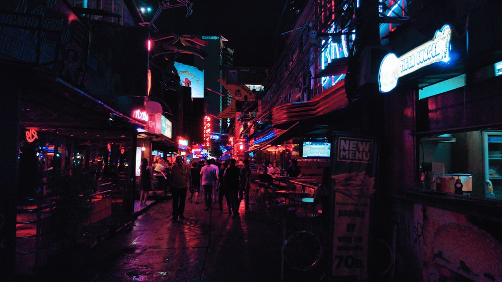 people walking on pathway near buildings during night time