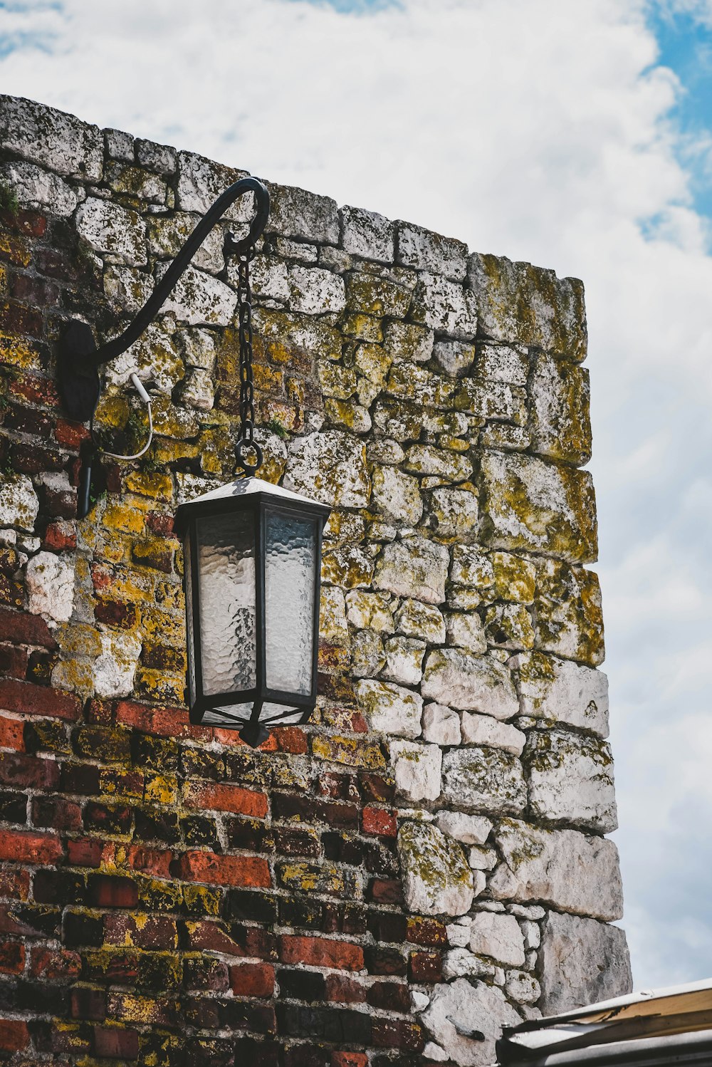 black metal outdoor sconce near brown concrete wall