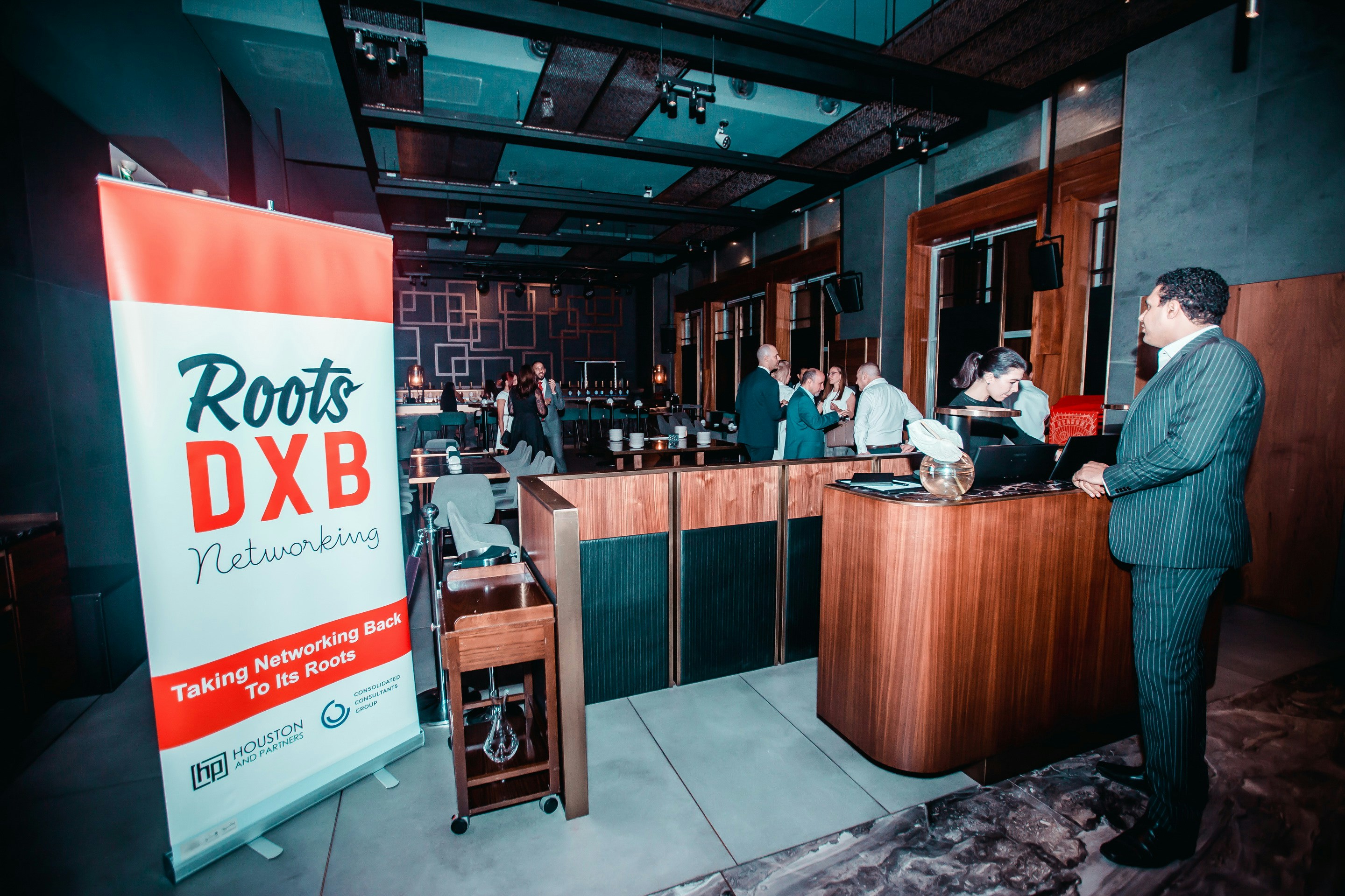 Roots DXB Networking sign near people inside building photo – Free ...