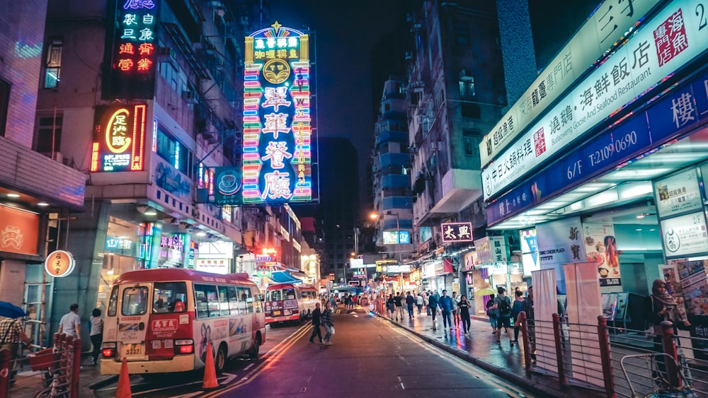 people on street beside building during nighttime