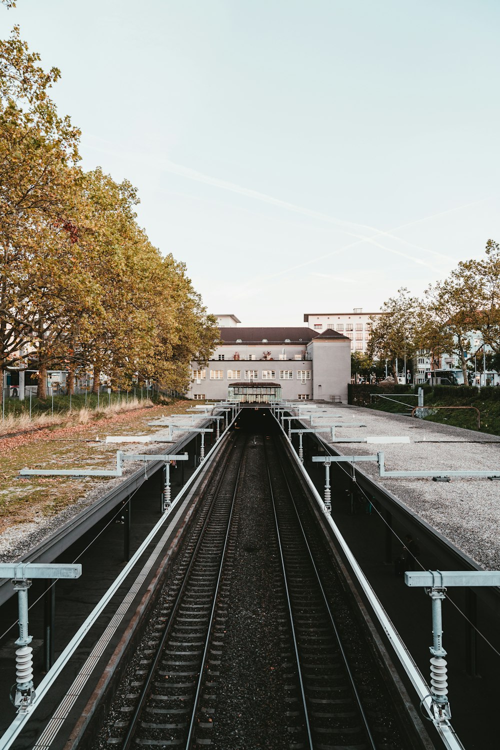a train track with a building in the background