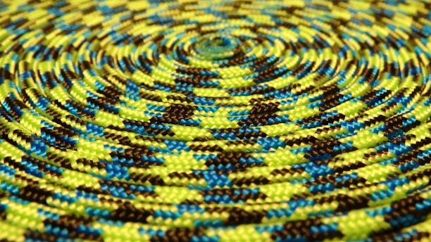 Close-up of a thick, braided Bharat Rope 7 Star brand rope coiled neatly.
