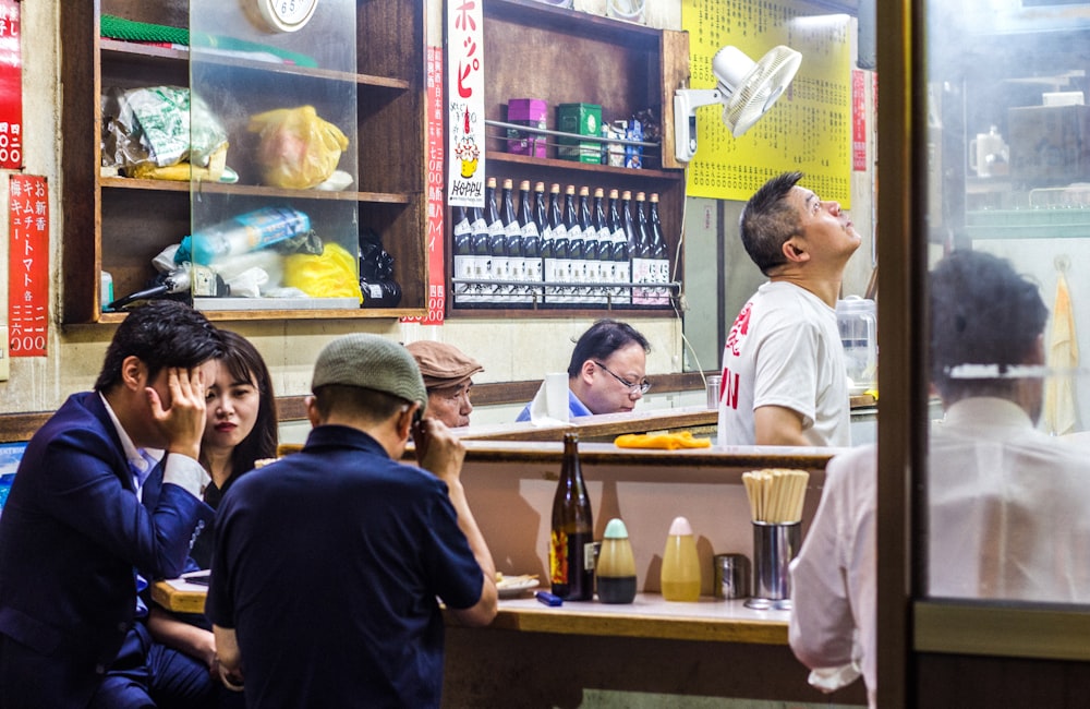 people sitting by the table inside cafe