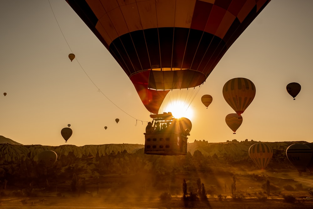 multicolored hot air balloons above mountain during daytime