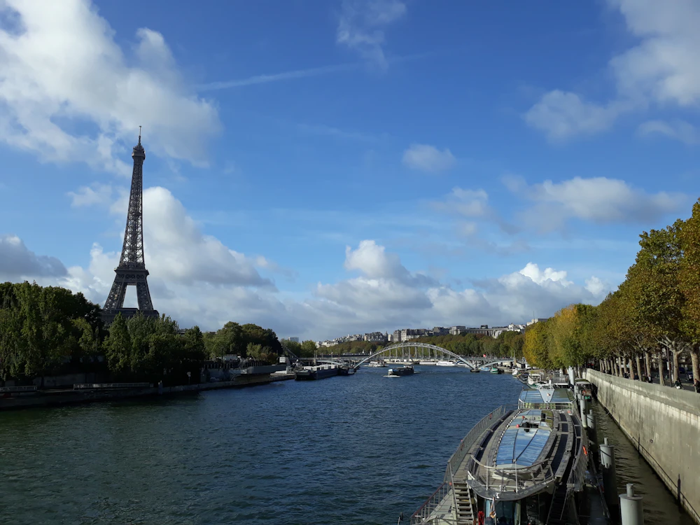 The Eiffel Tower above the River Seine on a bright day