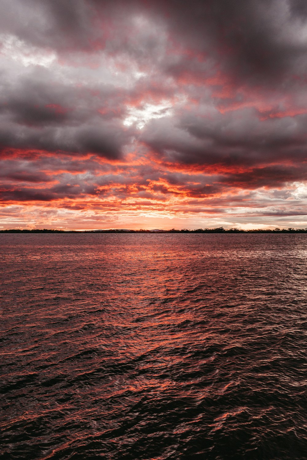 sea under gray and red sky