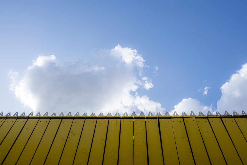 beige fence under cloudy sky