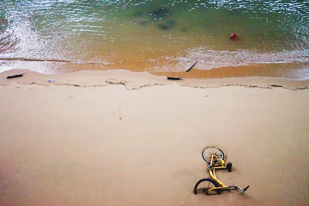 yellow bicycle near ocean