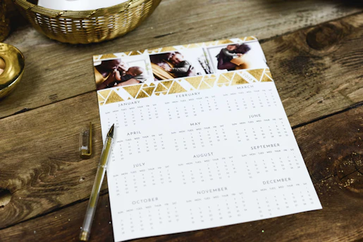 black ballpoint pen near calendar