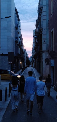 A diverse group of women walking confidently in a well-lit urban area at dusk.