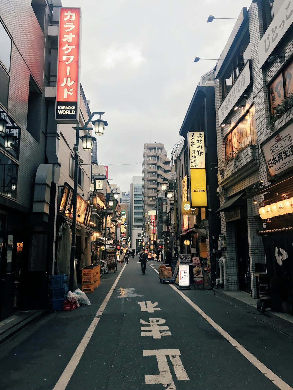 people walking on street between buildings