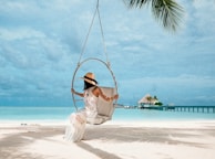 woman in white dress sitting on swing
