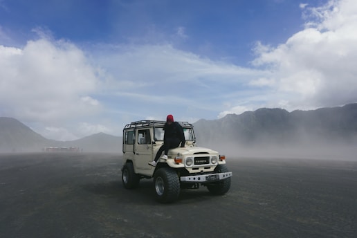 person on white Jeep wrangler