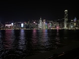 Abstract city skyline illuminated with electric neon lights at night.