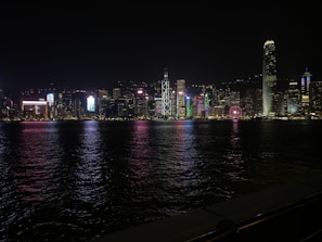 Abstract city skyline illuminated with electric neon lights at night.