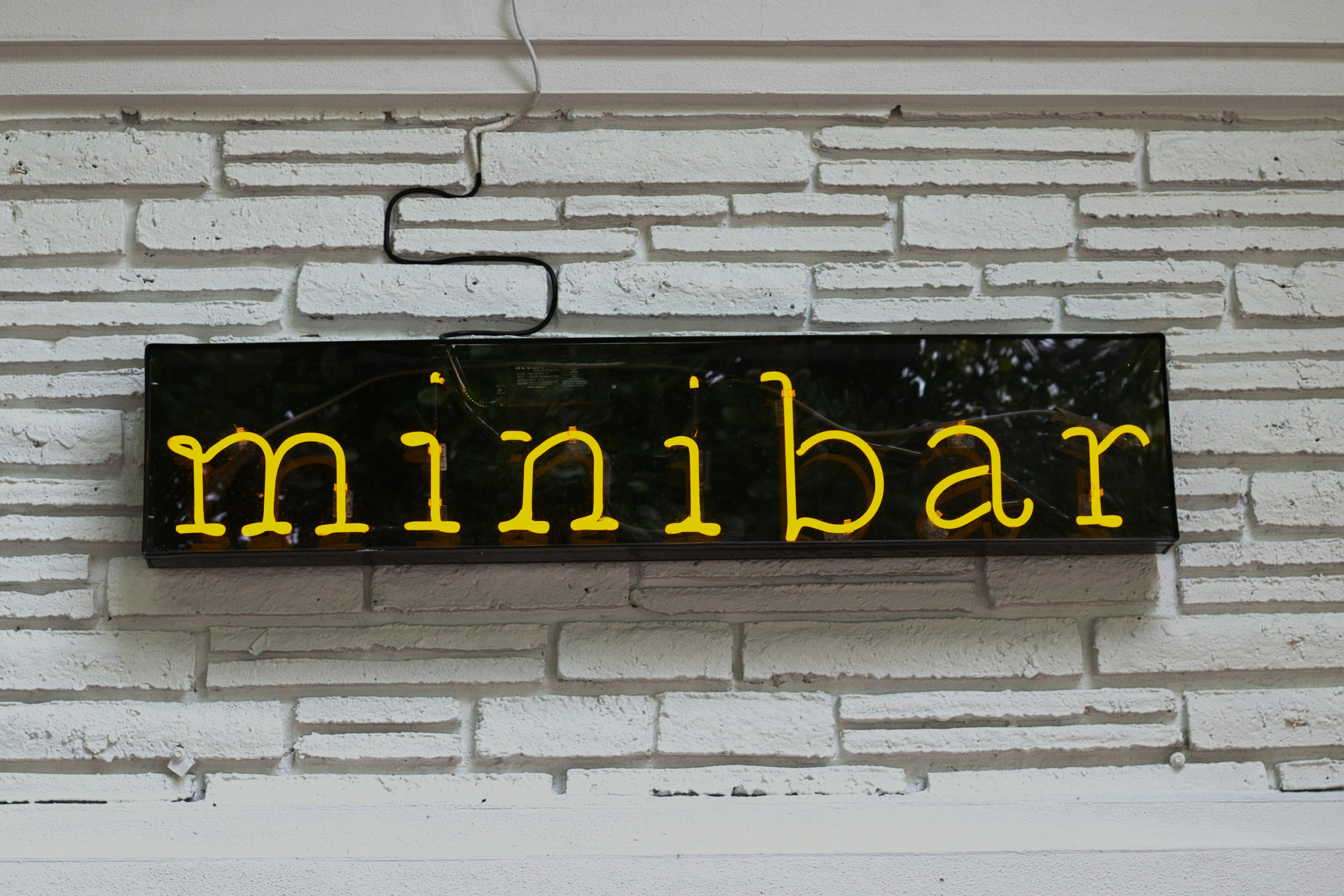 yellow and black LED Minibar signage