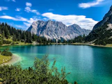 Glacial lake and mountains under blue sky