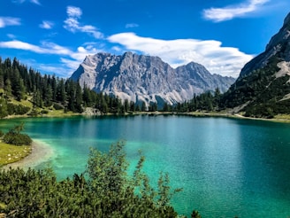 Glacial lake and mountains under blue sky