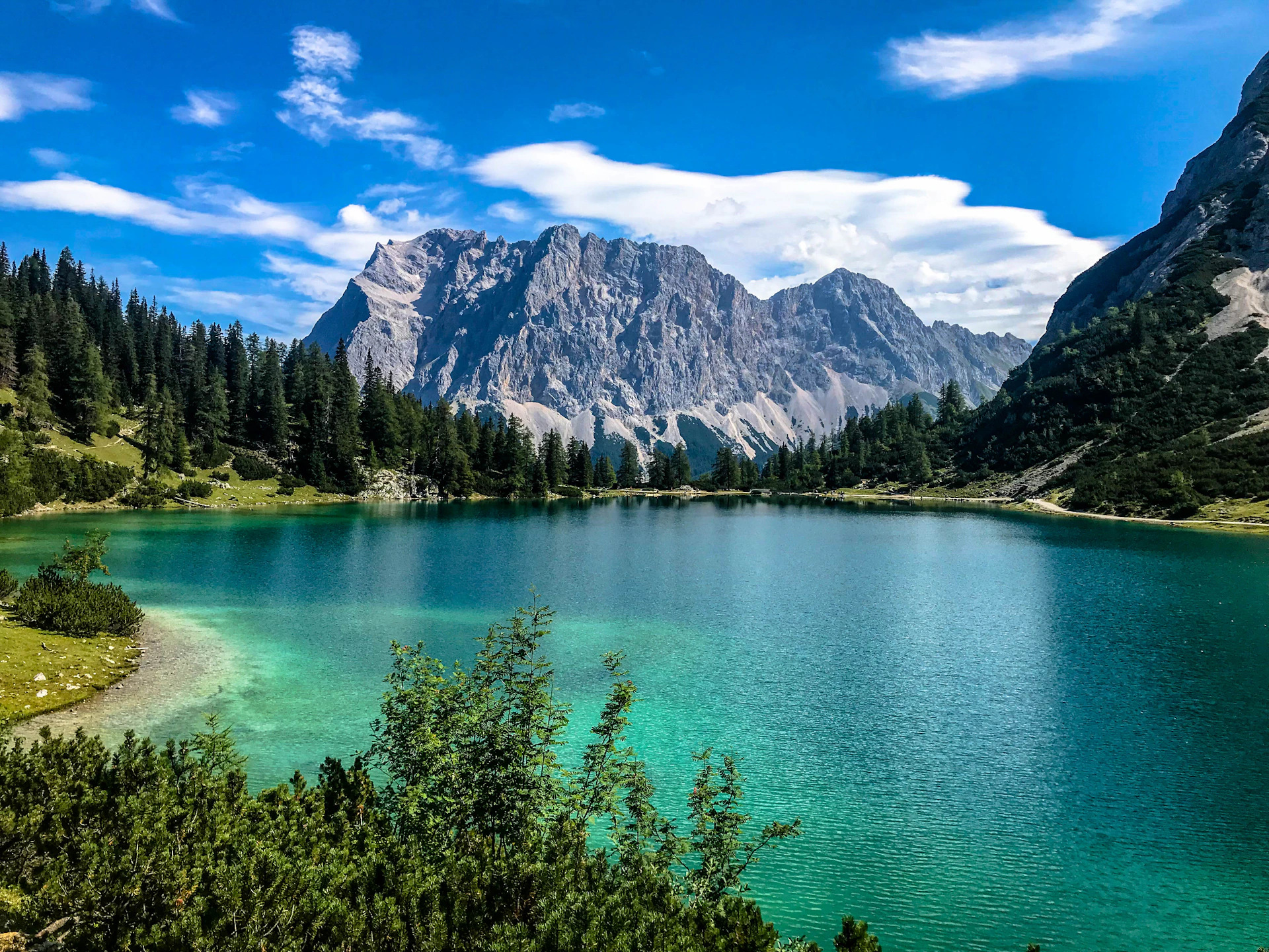 Glacial lake and mountains under blue sky