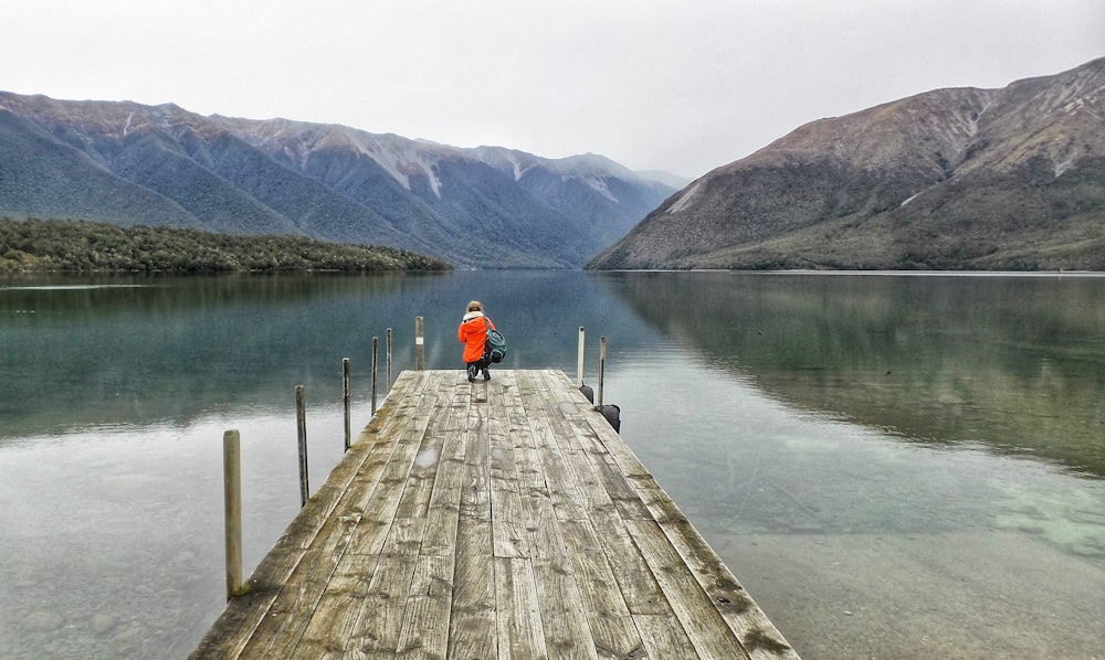 woman standing on dock near body of wtaer