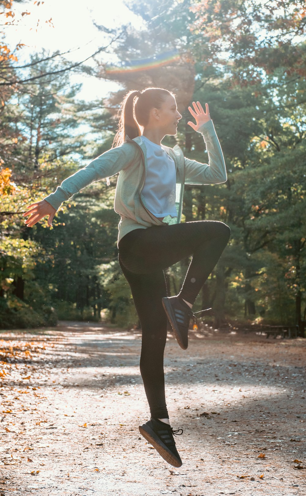 woman dancing near trees