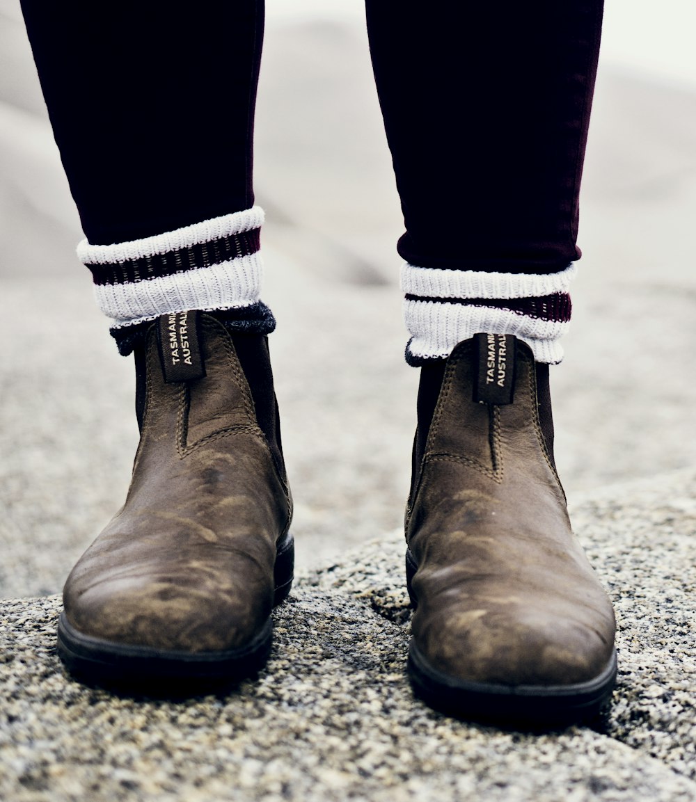 man wearing brown Chelsea boots