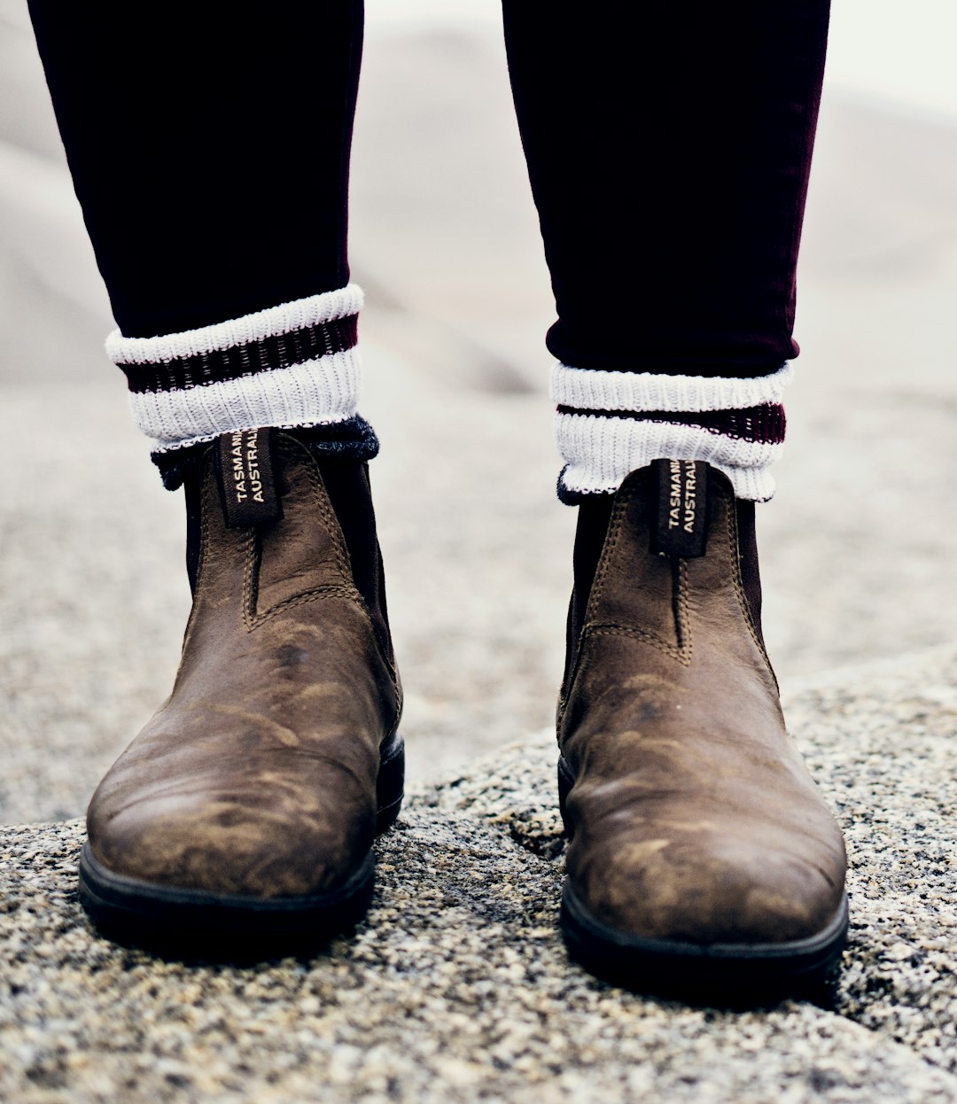 man wearing brown Chelsea boots