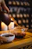 A serene scene of a teapot pouring tea into a cup surrounded by green leaves.