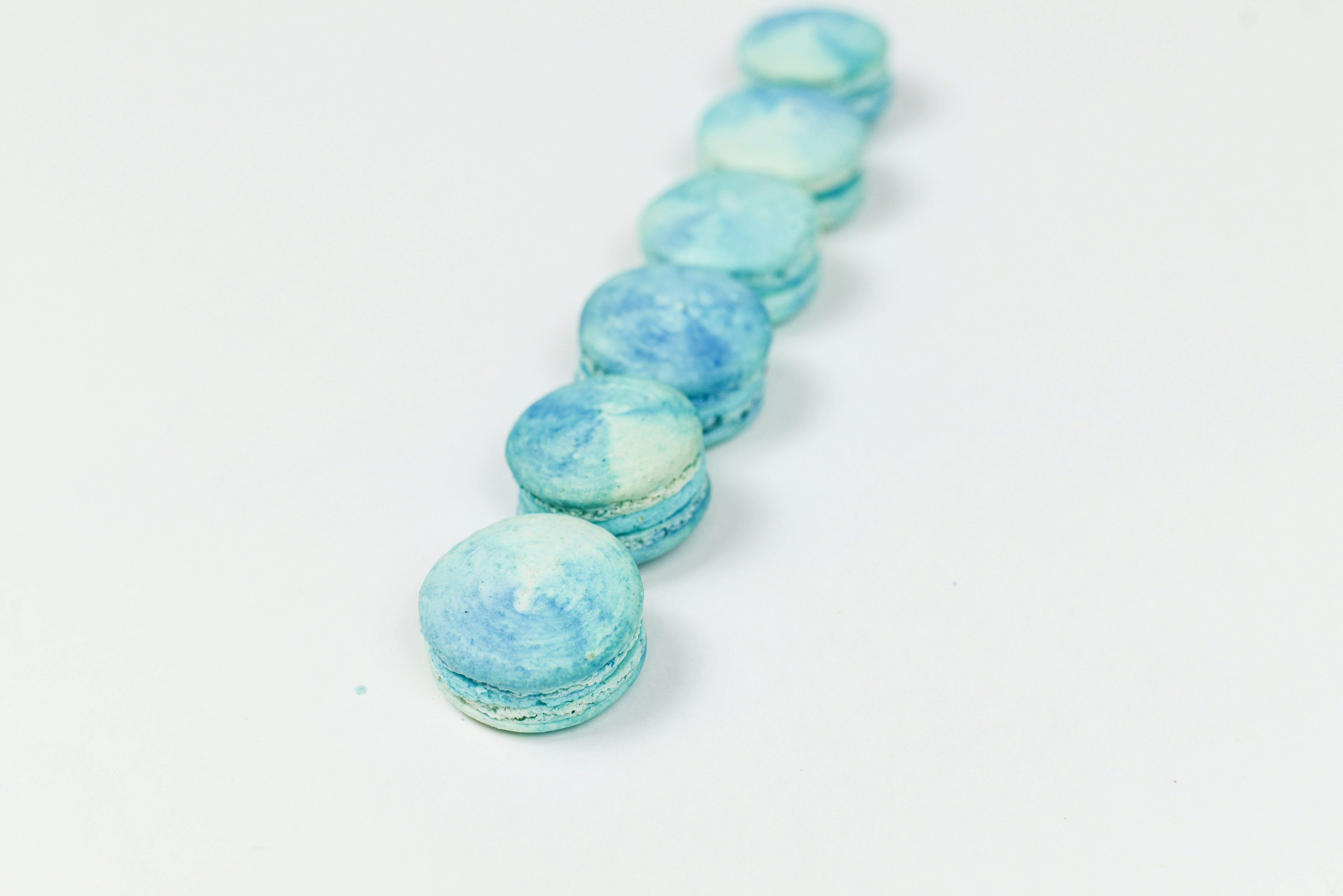 six teal macaroons turquoise teams background